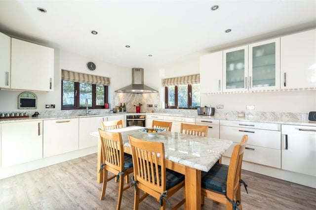 The dual aspect kitchen/breakfast room has a range of cream fronted high gloss units with granite work surfaces incorporating a sink and drainer. Integrated appliances include an electric oven with warming drawer, an induction hob with extractor over, a dishwasher and larder fridge