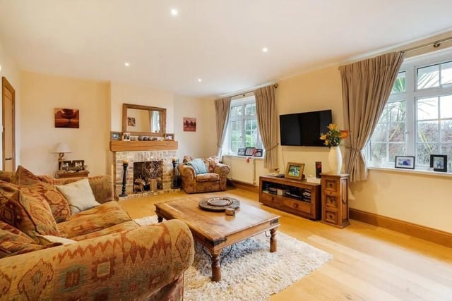 The sitting room has views over the gardens and a brick open fireplace. Picture: Savills - Haywards Heath.