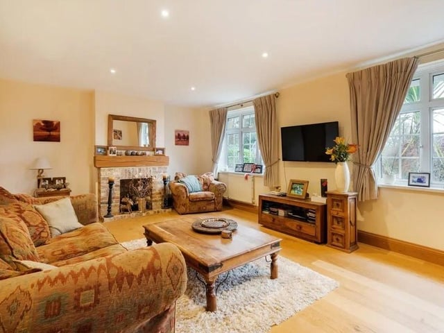 The sitting room has views over the gardens and a brick open fireplace. Picture: Savills - Haywards Heath.