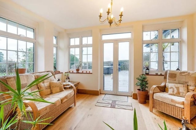 The property features a dual-aspect sun room with French doors opening to a decked terrace. Picture: Savills - Haywards Heath.
