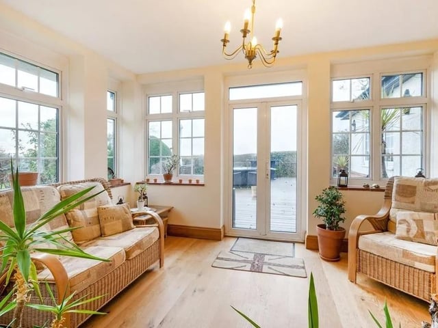 The property features a dual-aspect sun room with French doors opening to a decked terrace. Picture: Savills - Haywards Heath.