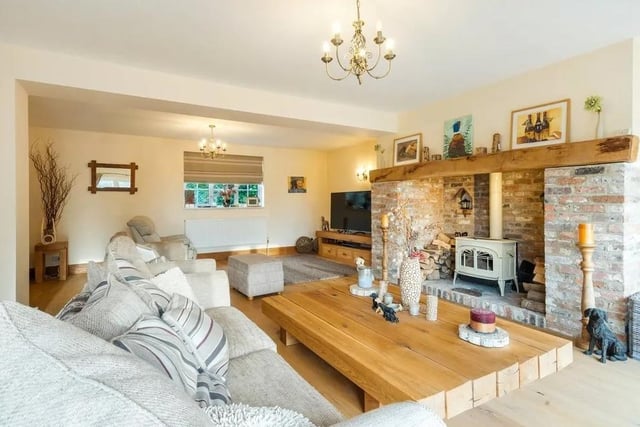 The large drawing room features a brick inglenook fireplace with a woodburning stove Picture: Savills - Haywards Heath.