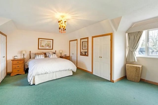 The large principal bedroom has built in wardrobes and an en suite bathroom. Picture: Savills - Haywards Heath.