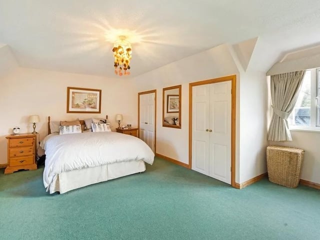 The large principal bedroom has built in wardrobes and an en suite bathroom. Picture: Savills - Haywards Heath.