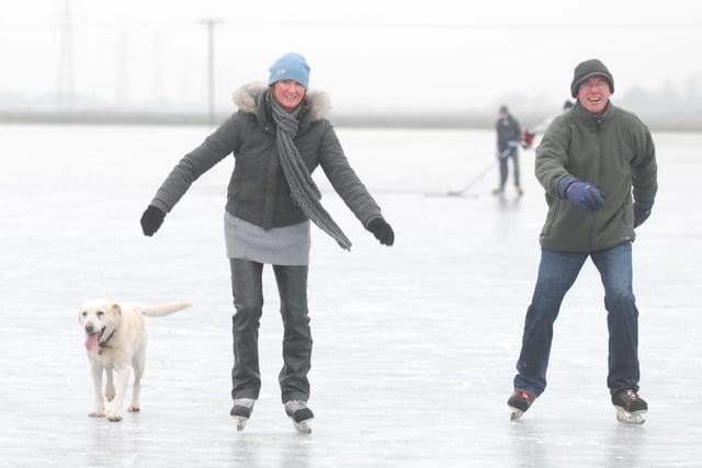 2009:  Ice on the Whittlesey washes. Hugh and Anna Whittome skating with their dog Cara.