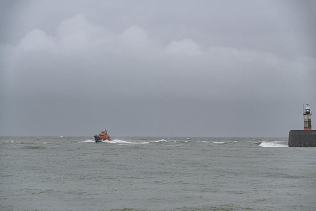 The RNLI lifeboat returns to base at Newhaven as heavy rain and 40 mile an hour winds batter the south coast of Britain