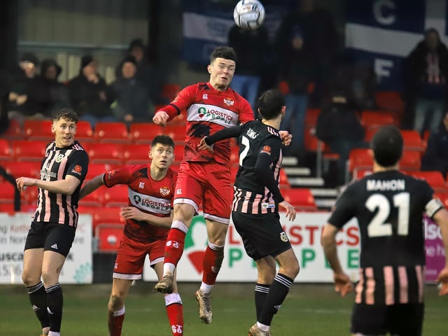 Connor Barrett gets up to win a header