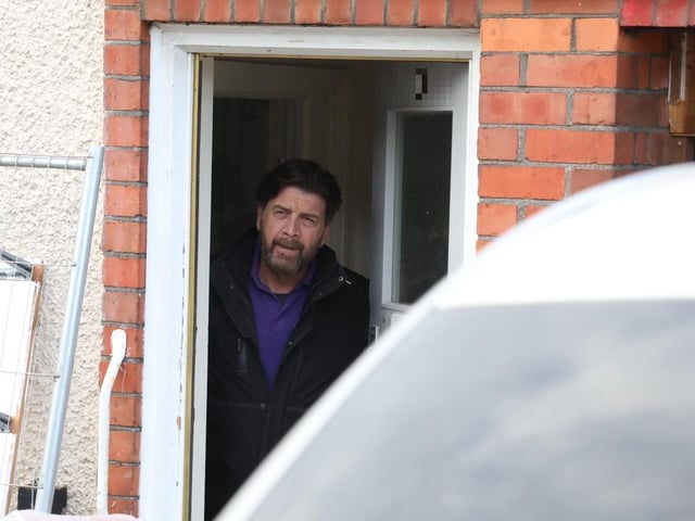 Nick Knowles in the doorway of the house that is to be transformed in a week by volunteers