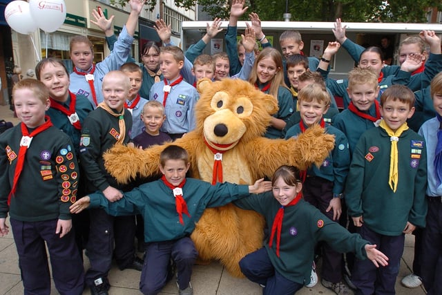 George the Bear with cubs and scouts publicising the Gang Show in Bridge Street.