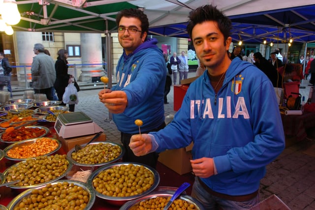 Street traders Amir Parhiz and Hamed Ghahrieh offer olives to shoppers in Bridge Street, during celebrations marking the 60th anniversary of Peterborough's Italian community.