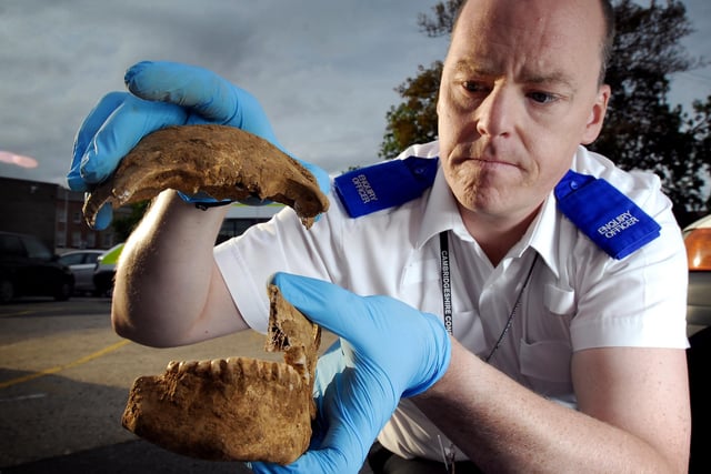 Enquiries officer at Bridge Street police station Jon Surtees carefully handles the human remains, including at least two cranium, one belonging to a child, fragments of jawbones, parts of a pelvis, femur and other bone fragments. They were found during building excavations at 10 Thorpe Park Road and are of historical and archaeological interest.
