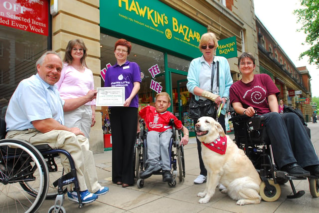 Manager of Hawkin's Bazaar Hannah Niedzwiecka is presented with a certificate from Disability Voices as the store on Bridge Street has become the first in the city to install a ramp for wheelchair users. L-R: Erik Vittins, Nicky Hampshaw, Hannah Niedzwiecka, Jason Merrill, Yvonne Saint-John and Lisa Berry.