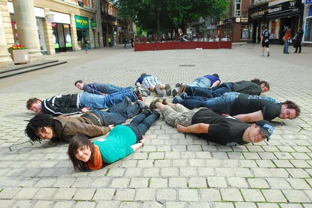 The Laying Down game -  A group of friends were attempting a public performance stunt by lying down in the middle of Bridge Street, part of a craze that was sweeping the world.