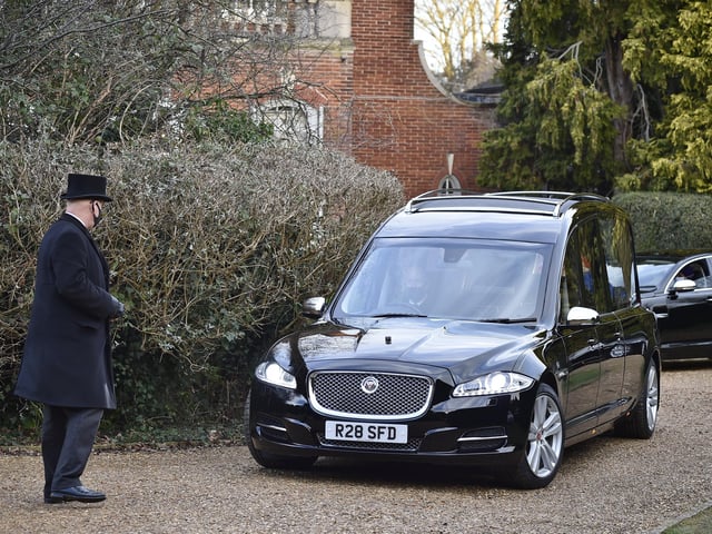 The hearse leaving his home at Thorpe Road.
