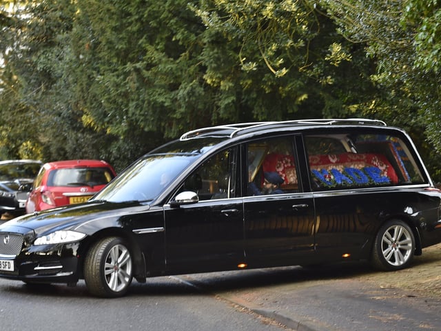 The hearse leaving his home at Thorpe Road.