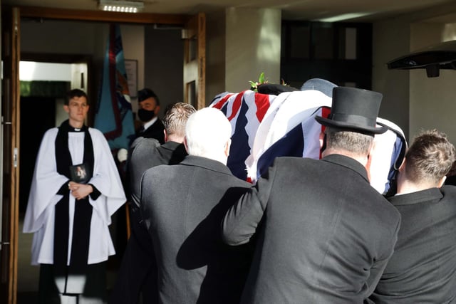 Rev Tom Houston receives Reg's coffin into the chapel