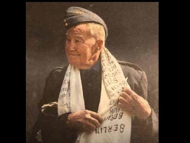 A portrait of Reg with his silk scarf and cap that were placed on his Union flag-draped coffin