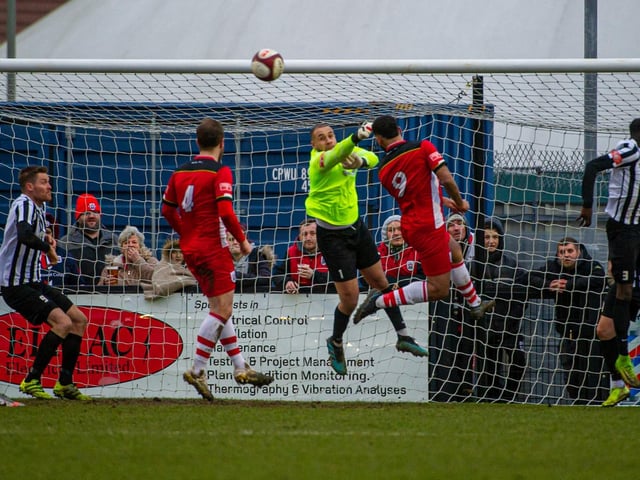 Steelmen goalkeeper Ben Heath punches away the danger