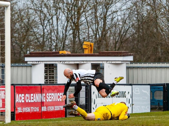 James Clifton takes a tumble over visiting goalkeeper Ross Durrant