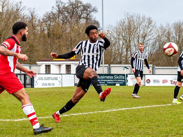 Northampton Town loanee Peter Abimbola clears the ball for Corby