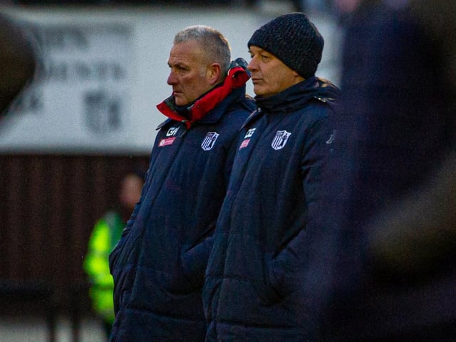 Corby manager Gary Mills and assistant Darron Gee watch on from the sidelines
