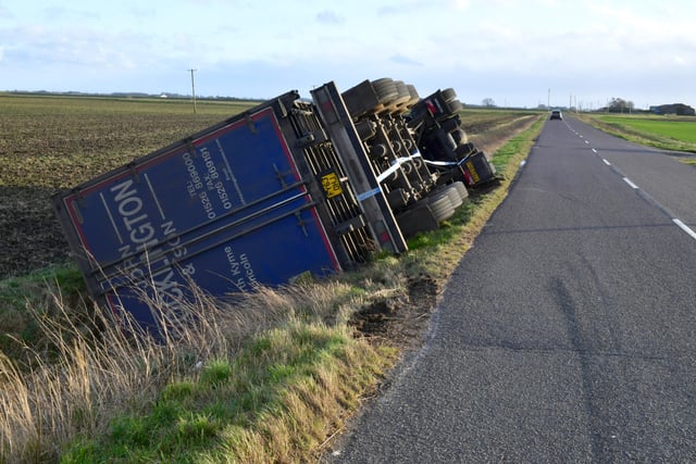 Overturned lorry at South Kyme in the high winds of Storm Eunice. EMN-220218-181753001