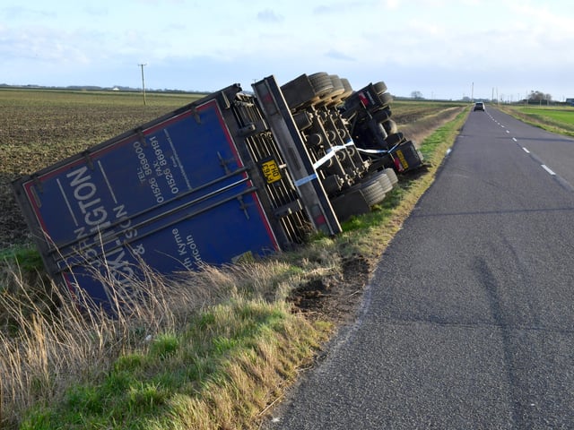 Overturned lorry at South Kyme in the high winds of Storm Eunice. EMN-220218-181753001