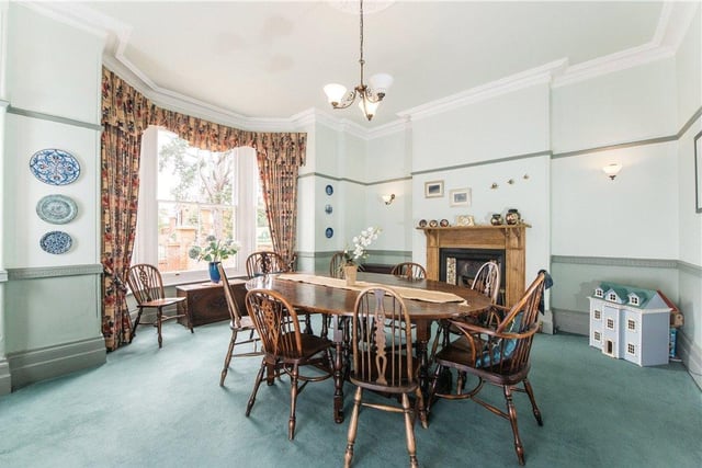 The dining room has an original sash bay window to the front and a traditional style fireplace housing a Living Flame gas fire