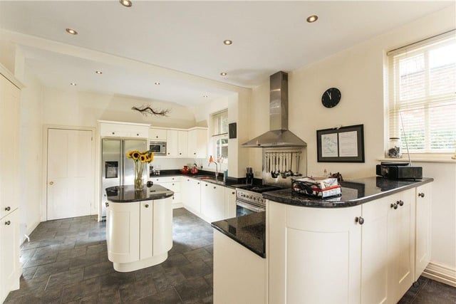 The kitchen is fitted with a range of cream fronted Shaker style cabinets with complementary granite work surfaces incorporating a sink and drainer. Integrated appliances include a range cooker with an extractor over, a dishwasher and a microwave and there is space and plumbing for an American style fridge/freezer