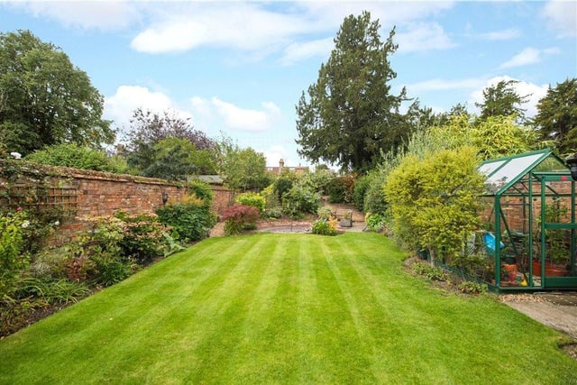 The gardens have been professionally landscaped and are on varying levels including a gravelled pathway at the rear. They are mainly lawned with well stocked borders and mature trees including fruit trees. There is a timber garden shed and a greenhouse
