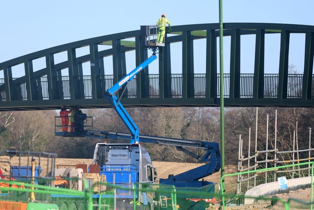Workmen use all their skills to get the bridge in place