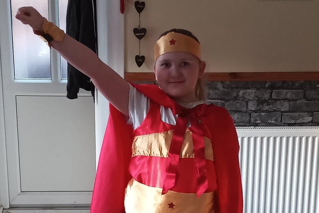 Lydia Cunnington, aged eight, wearing a Super Woman costume made by her nan to Eye CofE Primary School