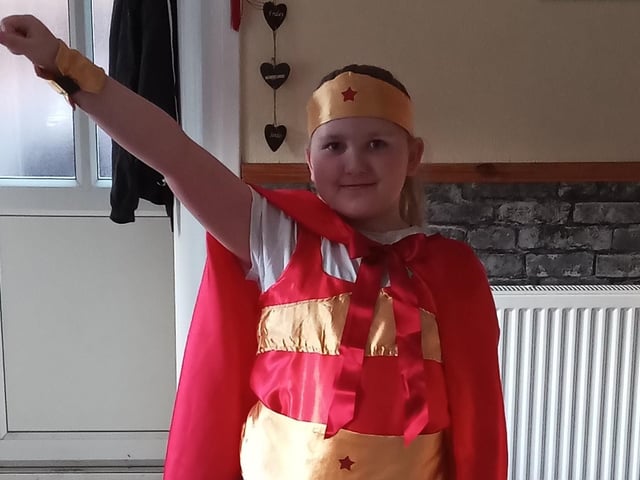 Lydia Cunnington, aged eight, wearing a Super Woman costume made by her nan to Eye CofE Primary School