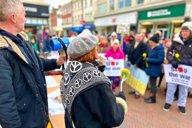 More than 100 people turned up to the protest in Worthing, with many bringing yellow flowers, Ukraine flags and home-made signs 'demanding an end to the war'. Speakers included veteran peace activists and anti-racism campaigners. Photo: @ThisWorthing