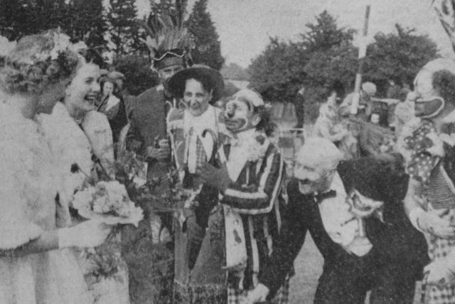 Rustington's Coronation Day princess and her attendants laughing with a group of clowns