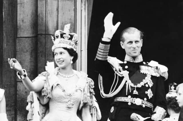 Her Majesty, wearing the Imperial State crown, smiling and waving from the balcony at Buckingham Palace with the Duke of Edinburgh after her Coronation at Westminster Abbey. Picture: INTERCONTINENTALE/AFP via Getty Images