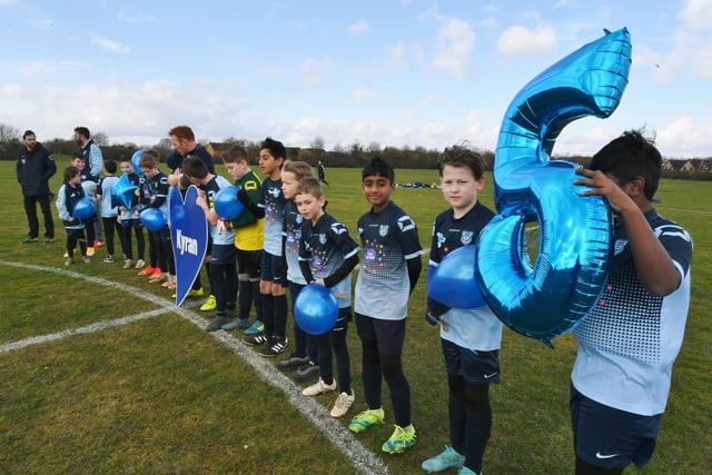 The Under 11's team take  part in a minutes silence before the game.
