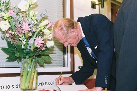 Prince Philip signing the visitors book at Carey House
