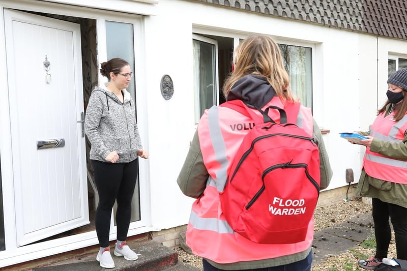 Catia Scott stands on her doorstep to speak to volunteers