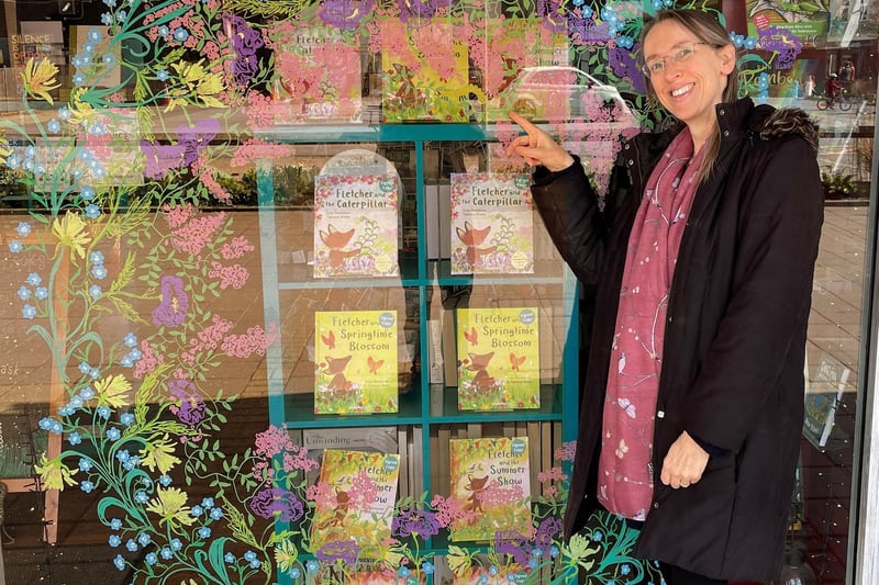 A beautiful window display greeted shoppers at the reopening of Kenilworth Books. It was painted by Tamsin Rosewell for Fletcher and the Caterpillar and the Fletcher’s Four Seasons books. Pictured here is the author Julia Rawlinson.
