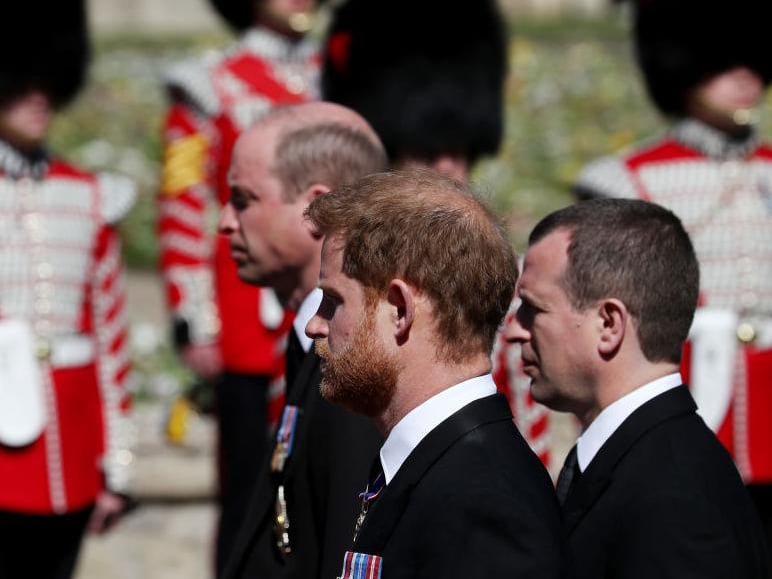 Peter Phillips walks between Princes William and Harry during the Ceremonial Procession to St George's Chapel