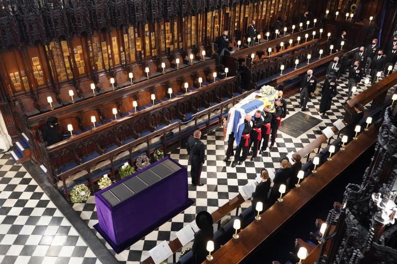 Queen Elizabeth II watches as pallbearers carry the coffin of the Prince Philip, Duke of Edinburgh, during his funeral at St George's Chapel at Windsor Castle