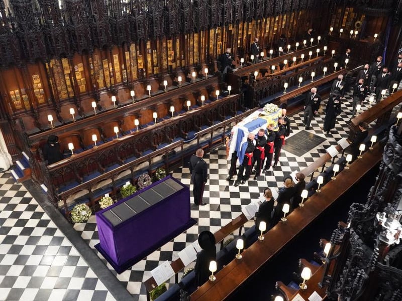 Queen Elizabeth II watches as pallbearers carry the coffin of the Prince Philip, Duke of Edinburgh, during his funeral at St George's Chapel at Windsor Castle