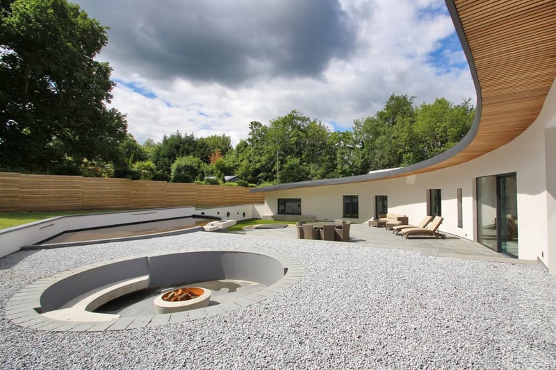 The terrace features a lowered fire pit with seating area