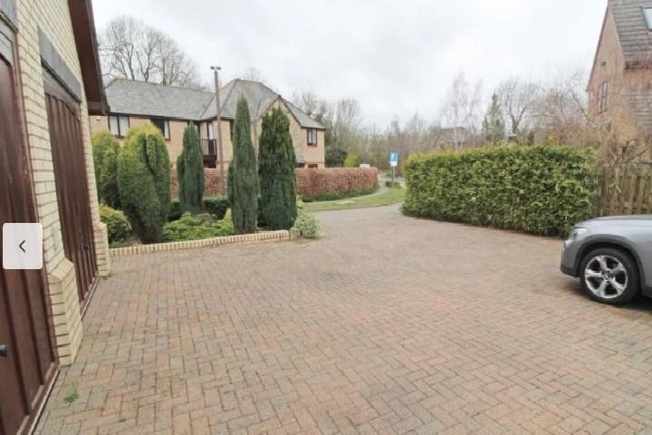 This photo of the driveway shows just how secluded the home is and how much privacy residents enjoy. You can also see the double garage, cars can be kept in.