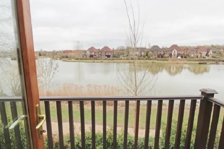 The first floor lakeside view, is glorious. This photo also highlights the ideal countryside surrounding the home, you can see the walking path, perfect for a run and hike around the lake.