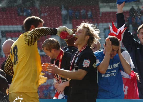 Paul Jones (left) and Craig Mackail-Smith celebrate the League One play-off final win at Old Trafford in 2011.