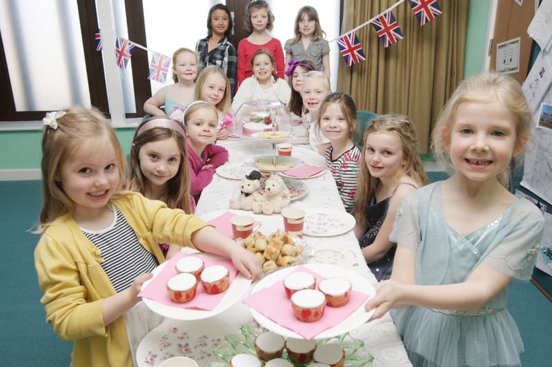 Mawsley Primary School pupils Amelia Bromham (5) and Eloise Watts (7) partake in a spot of tea and cake with fellow pupils at a Royal Wedding themed tea party