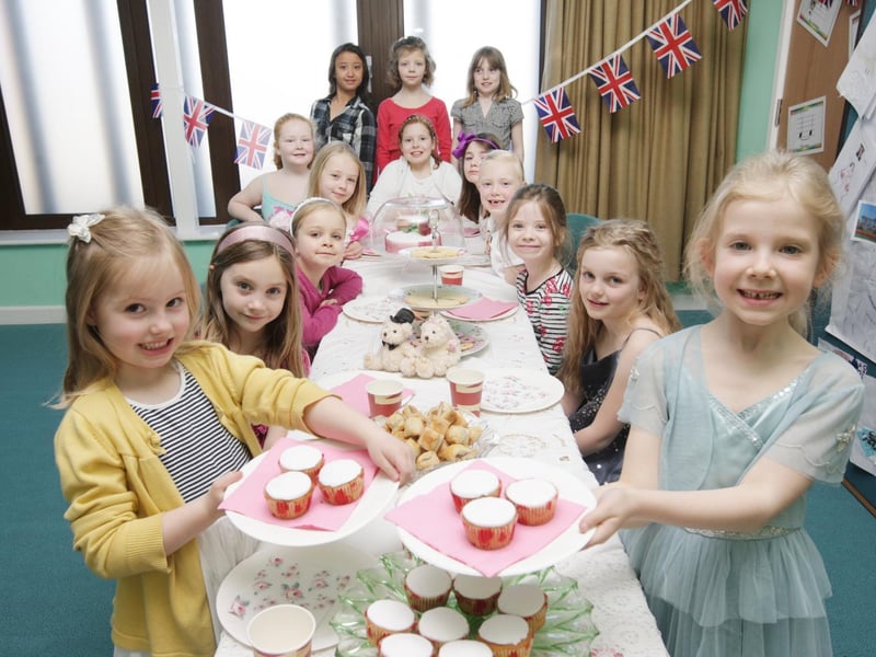 Mawsley Primary School pupils Amelia Bromham (5) and Eloise Watts (7) partake in a spot of tea and cake with fellow pupils at a Royal Wedding themed tea party
