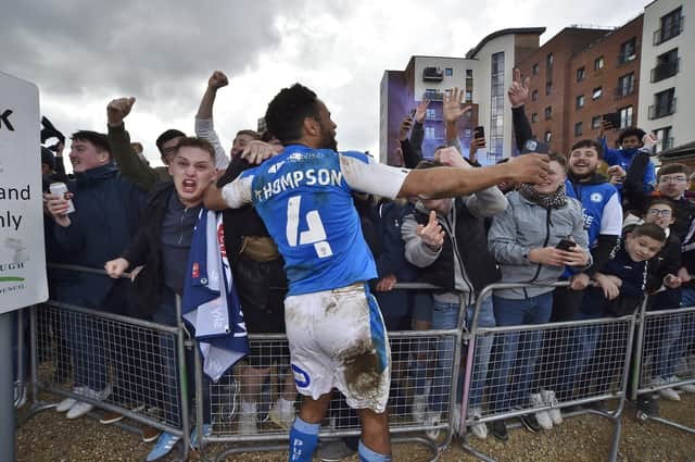 Posh drew with Lincoln City to gain promotion to the Championship triggering huge celebrations with fans outside the Weston Homes Stadium. Pictures: David Lowndes